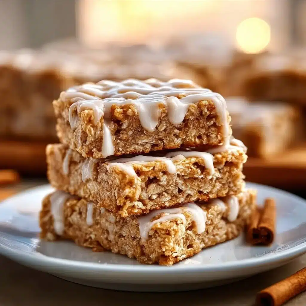 Delicious cinnamon roll oatmeal bars topped with icing and cinnamon.
