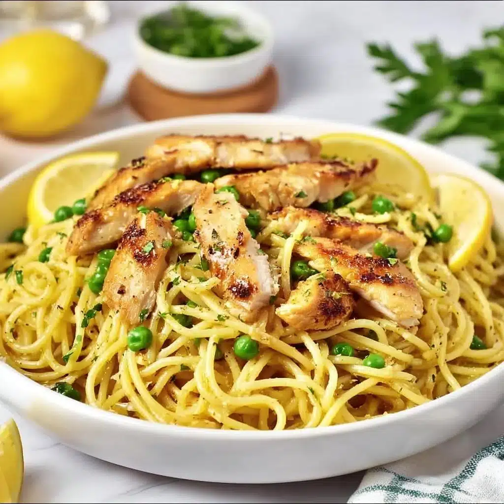 Creamy lemon chicken pasta dish garnished with herbs.