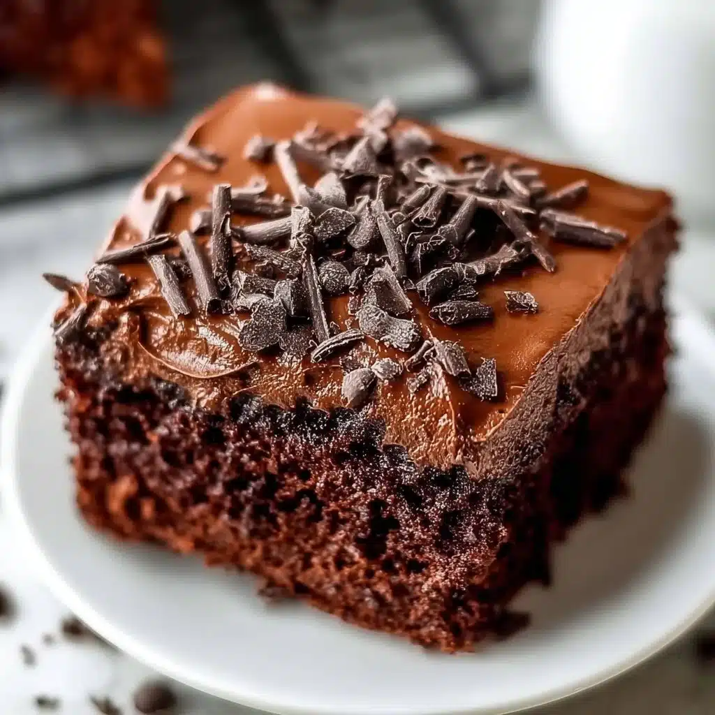 Delicious easy chocolate protein cake topped with chocolate icing on a plate