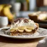 Delicious foolproof Banoffee Pie topped with bananas and whipped cream