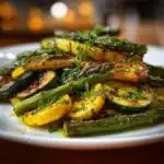 Delicious garlic roasted asparagus and zucchini dish served on a plate