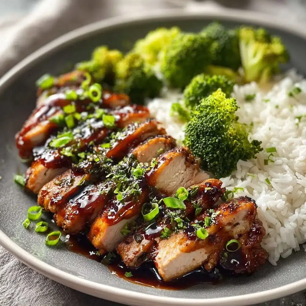 Plate of teriyaki chicken garnished with sesame seeds and green onions