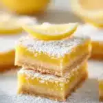 Classic lemon bars with a buttery crust and lemon filling served on a plate