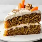 Slice of healthy carrot cake topped with cream cheese frosting