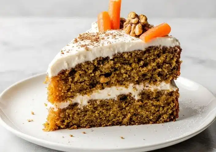 Slice of healthy carrot cake topped with cream cheese frosting