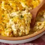 Oven-baked chicken and rice casserole in a baking dish, garnished with herbs